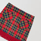 Plaid mini skirt in red, green and yellow with fringed detail at the bottom. 