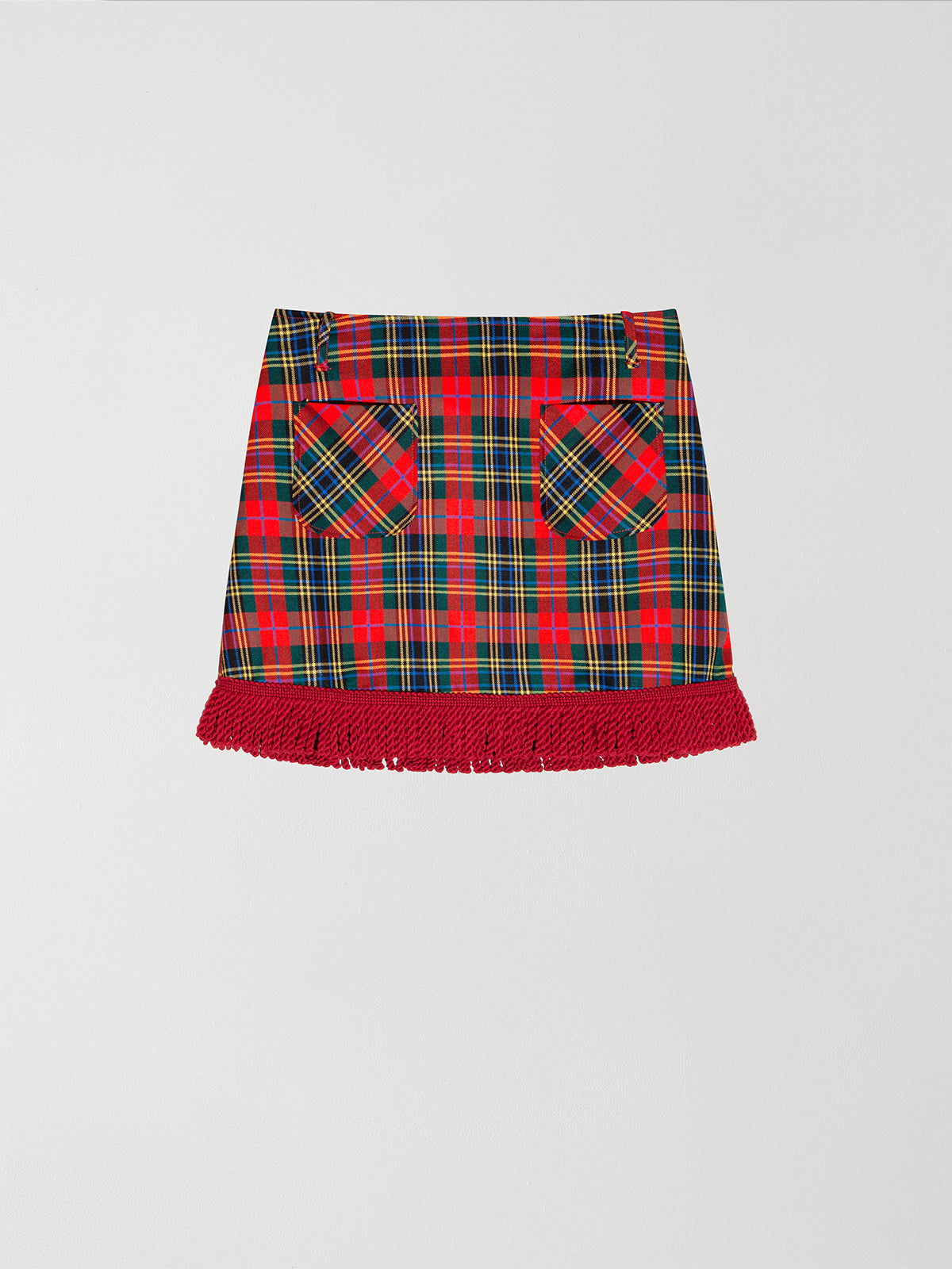 Plaid mini skirt in red, green and yellow with fringed detail at the bottom. 