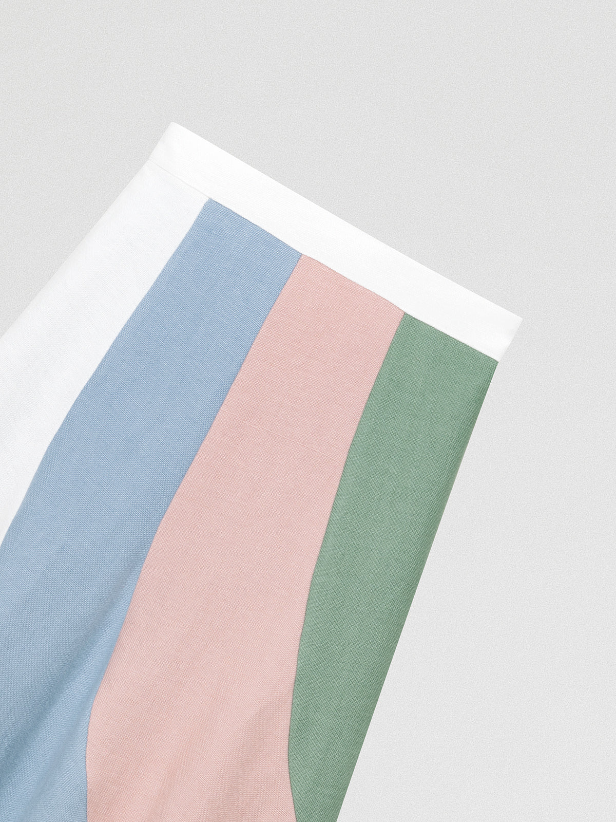 Flared linen midi skirt with asymmetric print in baby pink, baby blue, green and white.