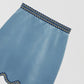 Light blue mini skirt made of velvet with a wavy finish.