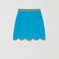 Blue mini skirt made of velvet with a wavy finish.