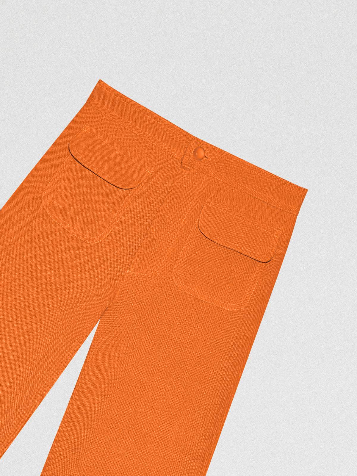 Orange high-waisted linen trousers with pockets. 