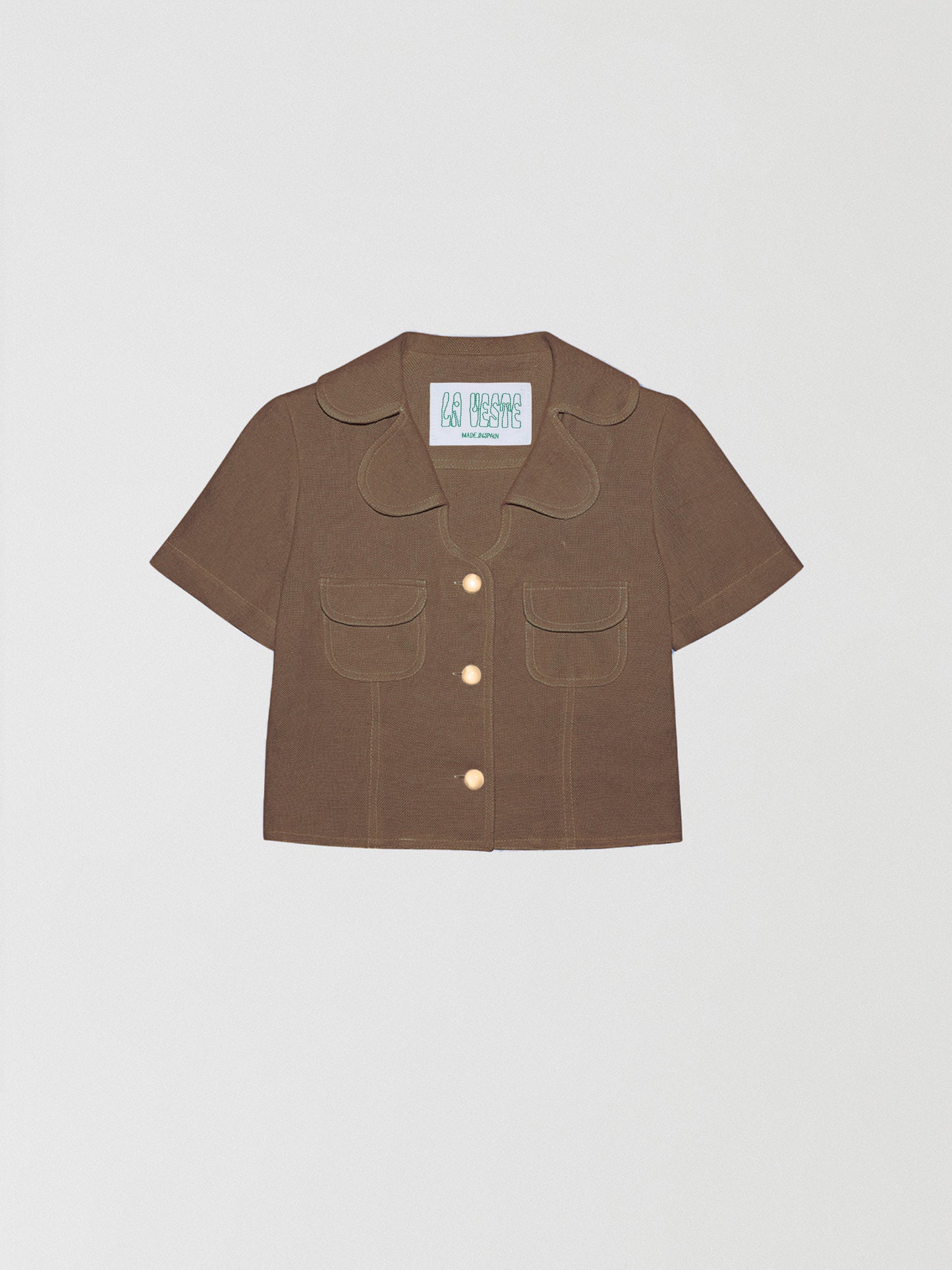 Loto Brown Shirt is a short-sleeved brown shirt with buttons and front pockets in the same color.