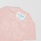 Women's short sleeve shirt made of light pink linen fabric.