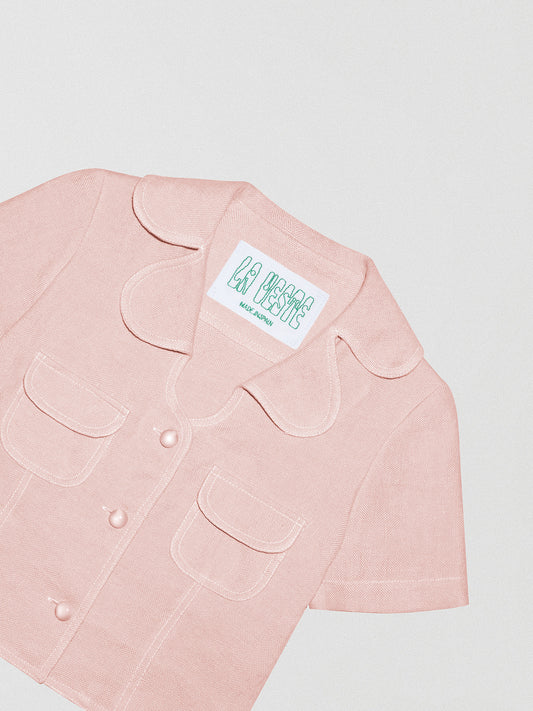 Women's short sleeve shirt made of light pink linen fabric.