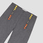 grey pants with colored button detail