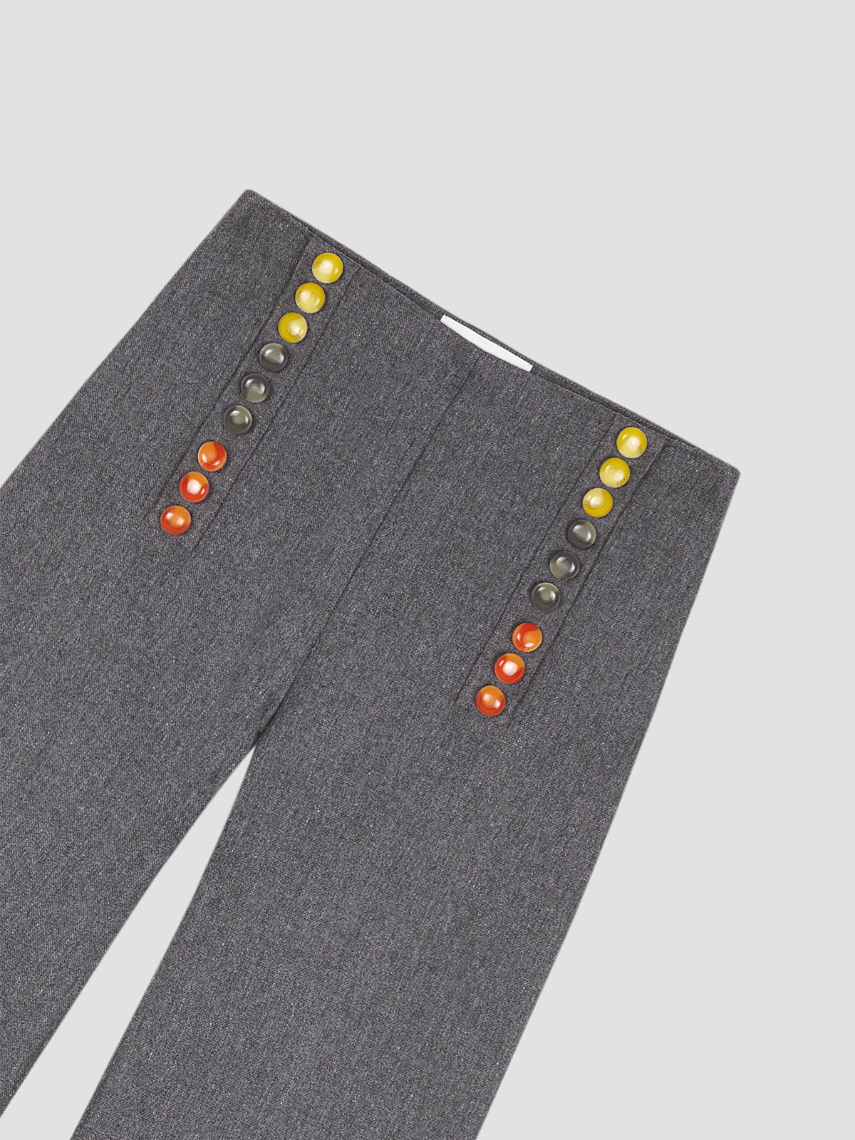 grey pants with colored button detail