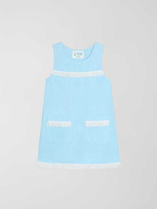 Fringes Mini Towel Celeste is a light blue dress made with towel fabric and white bangs on the pockets, chest and skirt.
