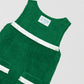Short green dress with white fringed details on the chest and skirt