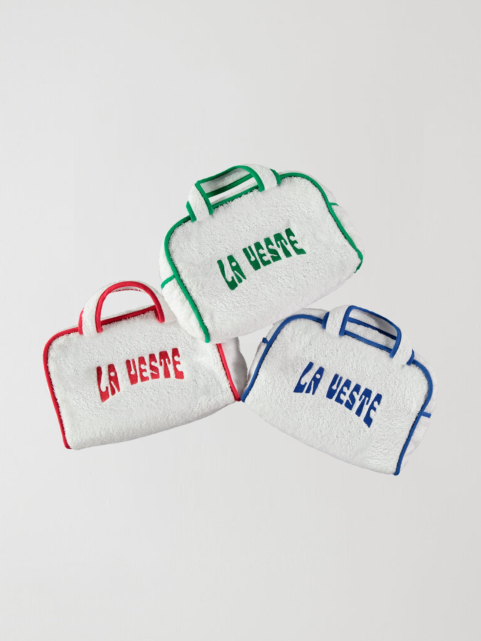 Bags made of cotton terry cloth with the La Veste logo in different colors.