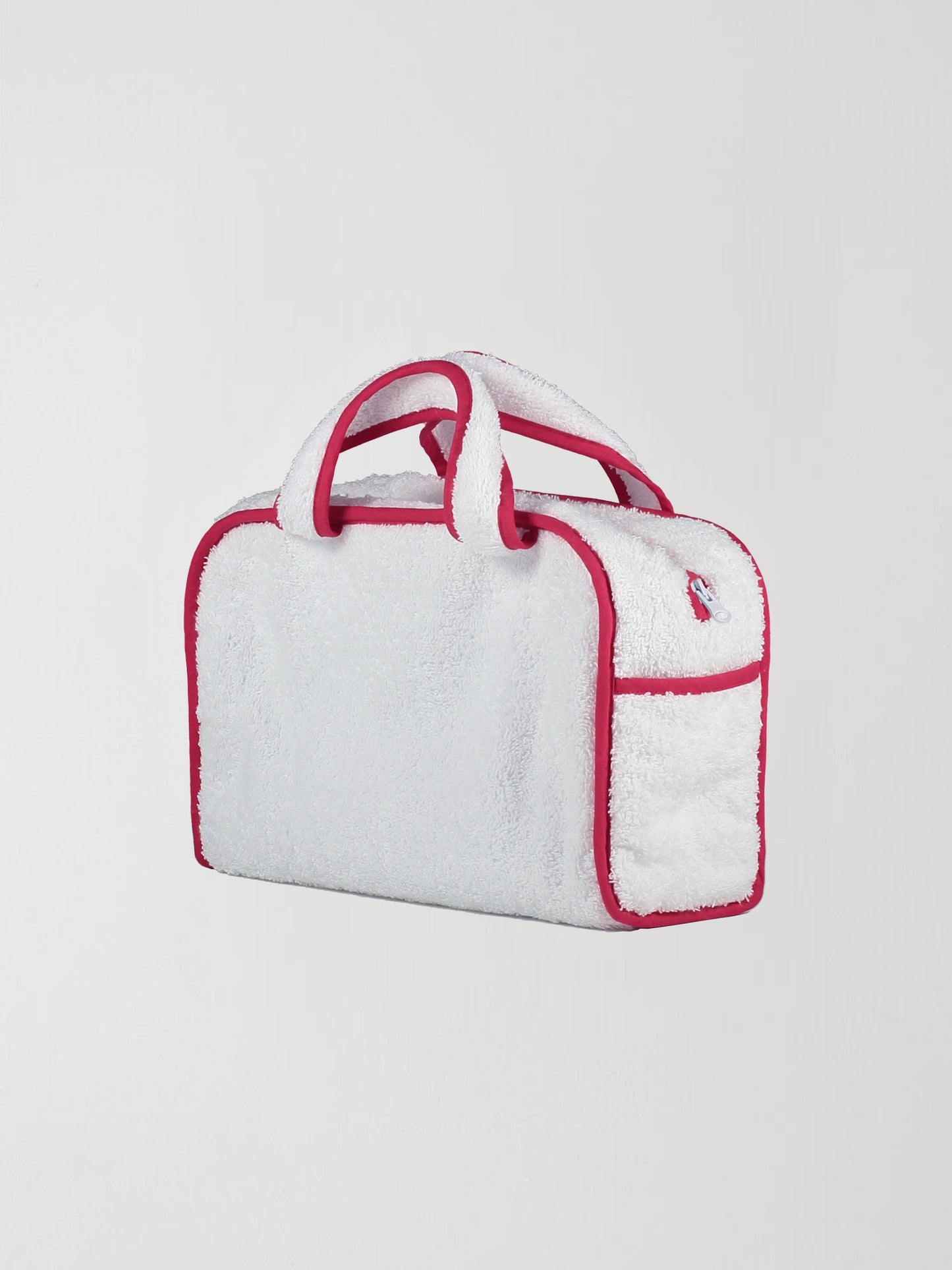 Back view of our white towel bag with red details on the edges and zipper closure.