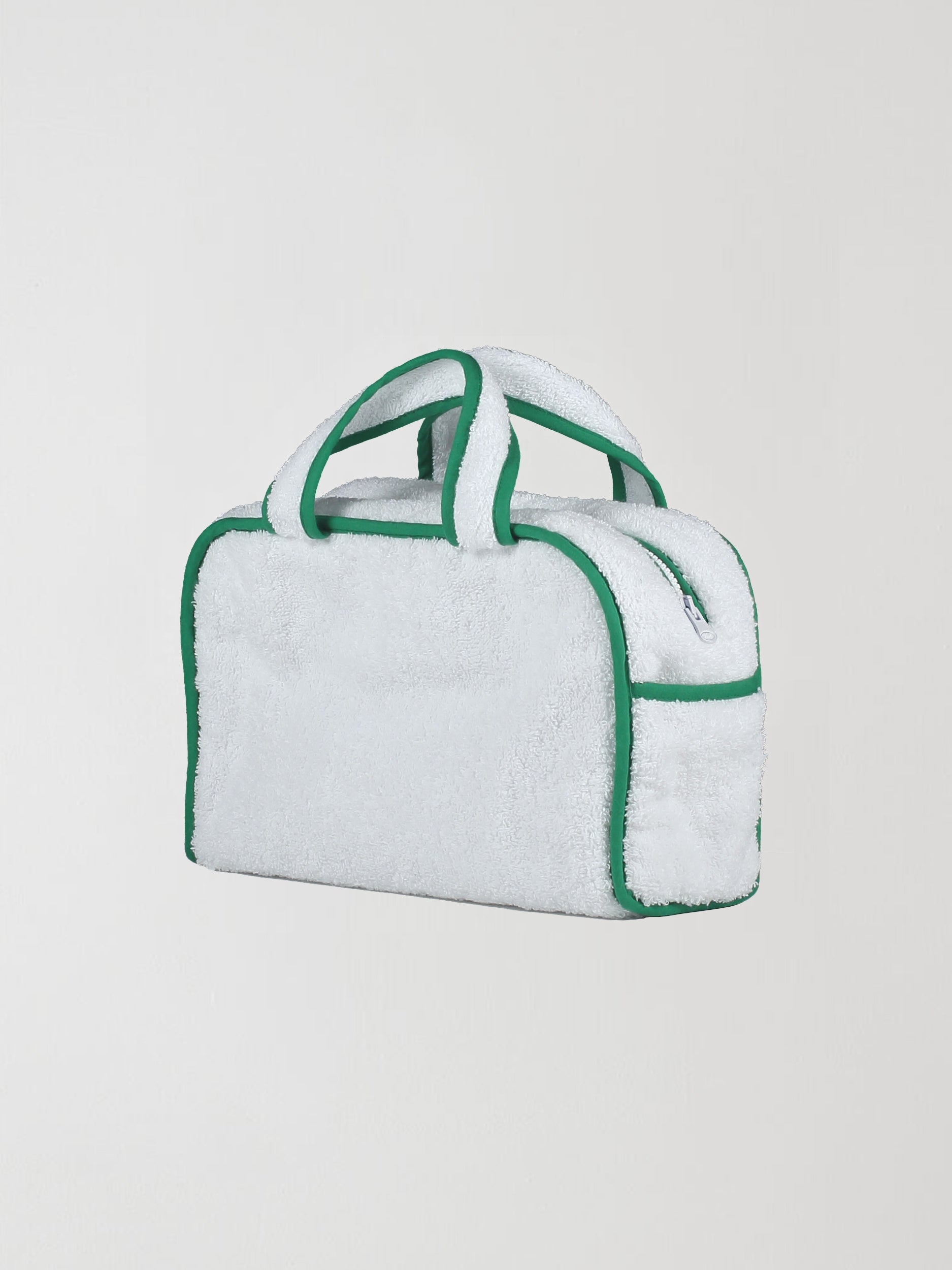 Back view of our towel bag made of white towel fabric with green details.