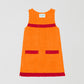 Fringes Mini Towel Orange is a short orange towel dress with red fringe detailing on the pockets and chest.