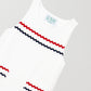 Short white dress with front pockets and red and navy blue piping details