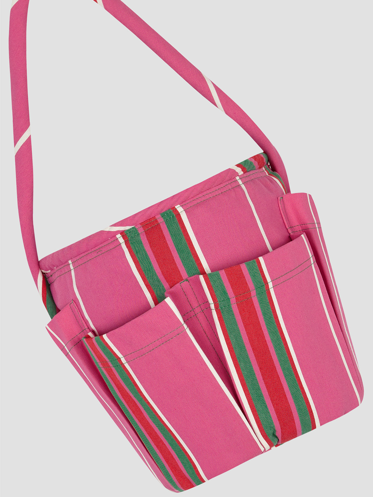 Round base bag in our iconic fuchsia Pippi fabric. It features a medium short handle and external pockets. 