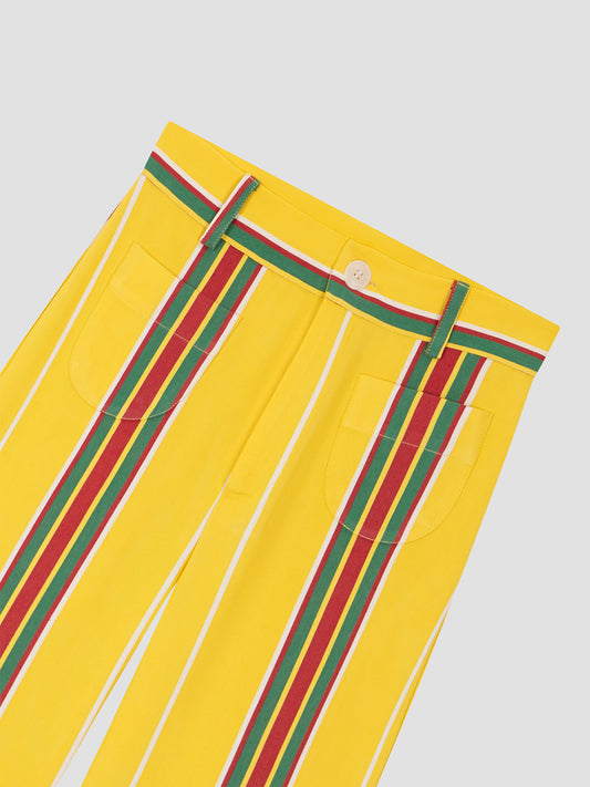 Yellow high-waisted printed trousers in cotton with red and green stripes. 