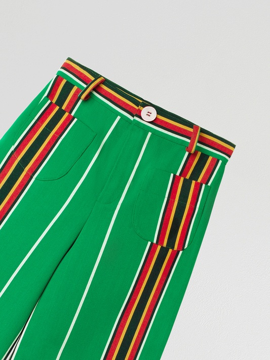 Green high-waisted printed trousers in cotton with red and yellow stripes. 