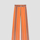 Orange high-waisted printed trousers in cotton with red and green stripes. 
