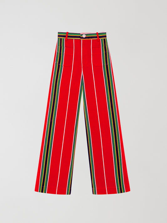 Red high-waisted printed trousers in cotton with yellow and green stripes. 