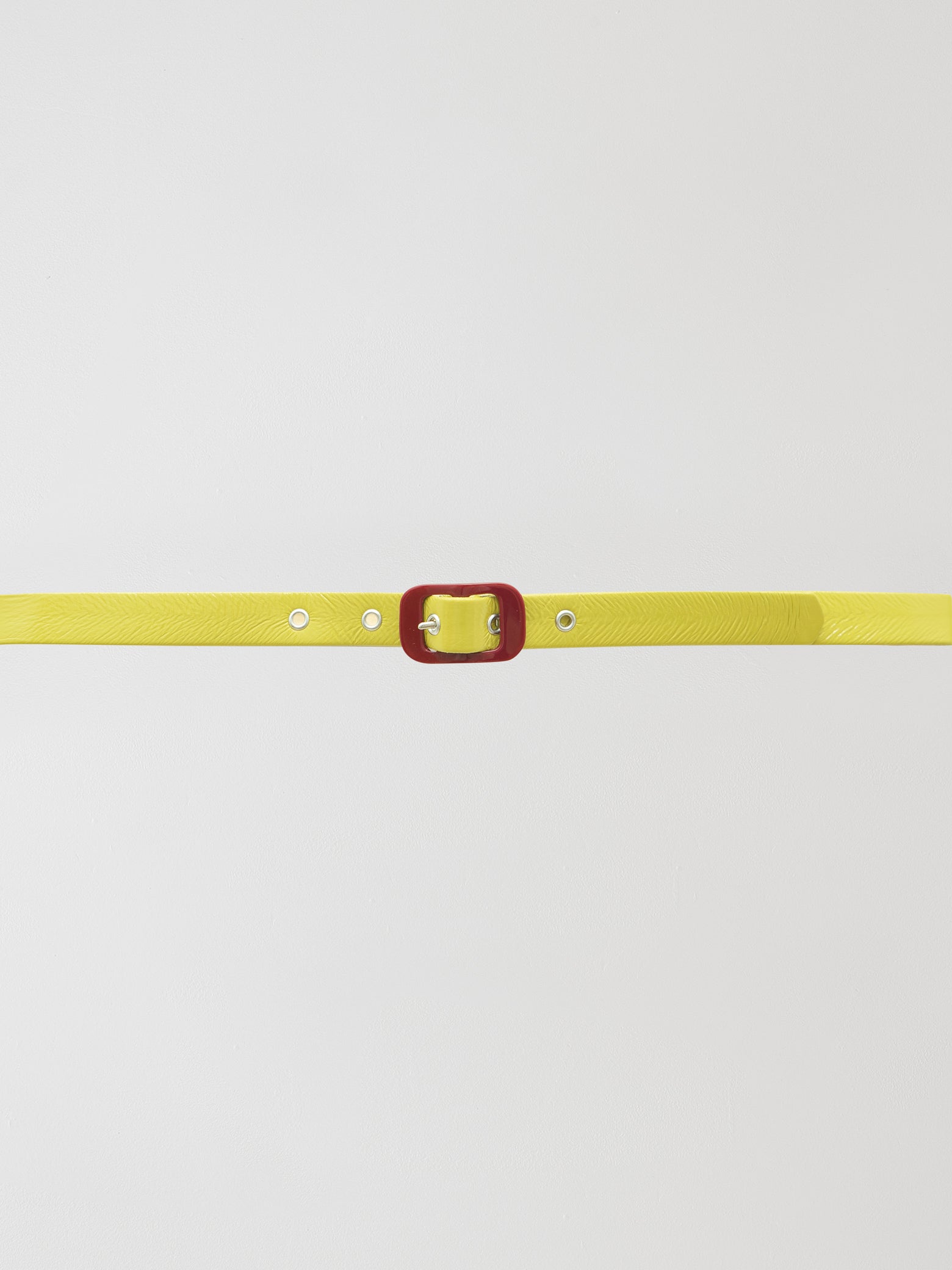 Pistacho vynil belt with adjustable buckle closure.