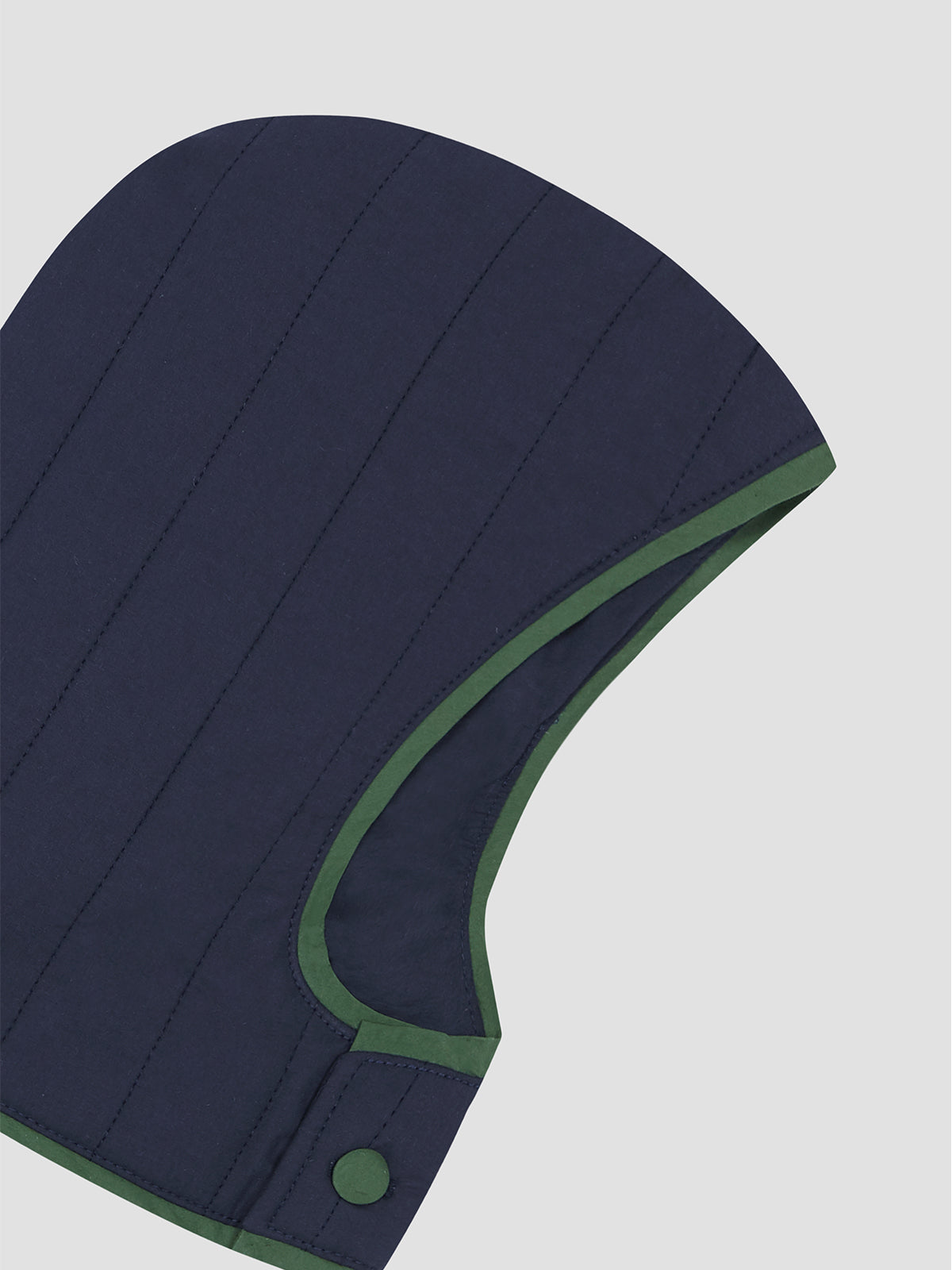 Navy blue cotton hood with green piping details at the edge and button closure