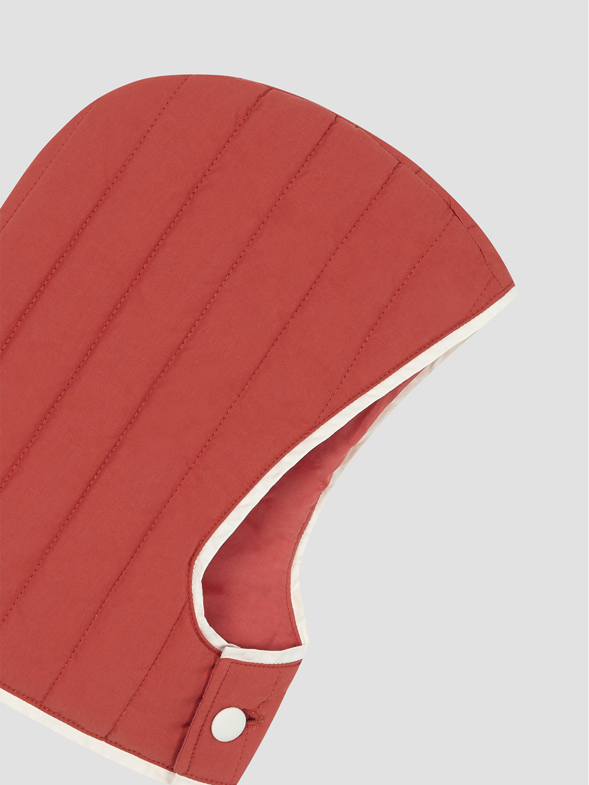 Red quilted hood with matching white trim detail