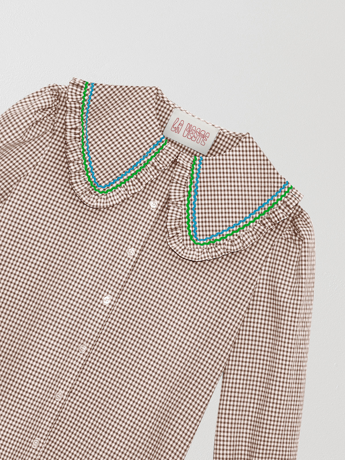 Brown and white vichy check shirt made of cotton with blue and green yarn detail on the collar