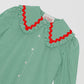 Green and white vichy check shirt made of cotton with red trim detail on the collar