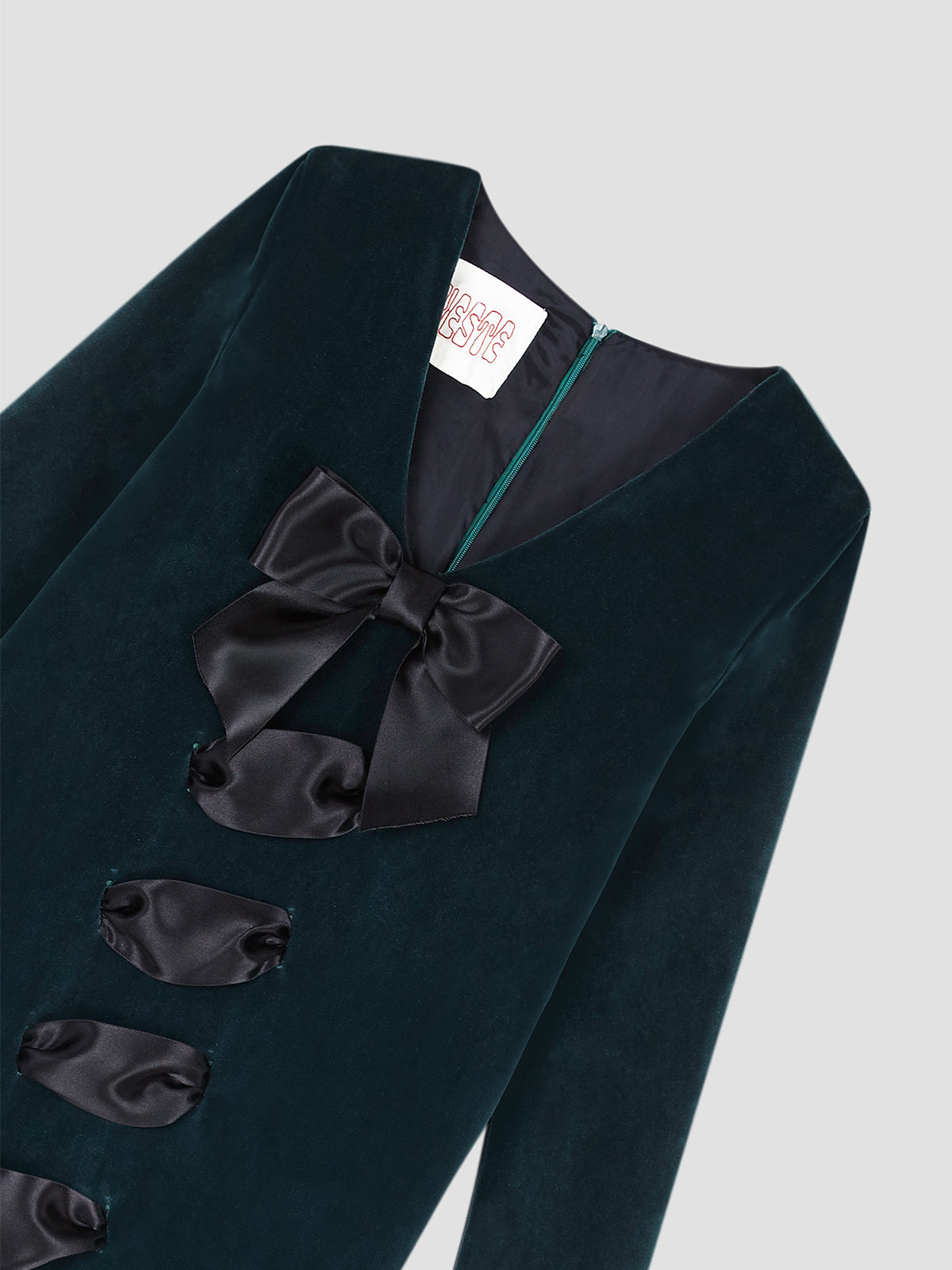 Color: Dark Green/Black.   Long dress made in dark green velvet with black satin bow on the front.   Regular fit. Long length.  V-neckline.  Long sleeves. Zipper closure at the back.