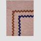 Tableclotha Mini Check Brown is a rectangular brown vichy check tablecloth with brown and blue trim.