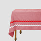 Dining table with a red vichy check tablecloth and matching red and white piping details