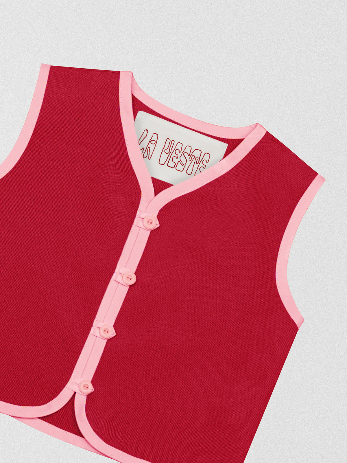Red cotton waistcoat with pink bias binding