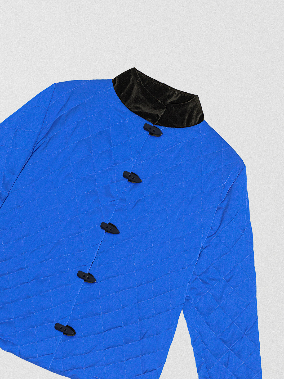 Blue padded jacket with black velvet details