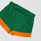 Towel shorts made in green cotton with orange fringe.