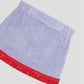 Towel mini skirt made in purple cotton with red fringes. 
