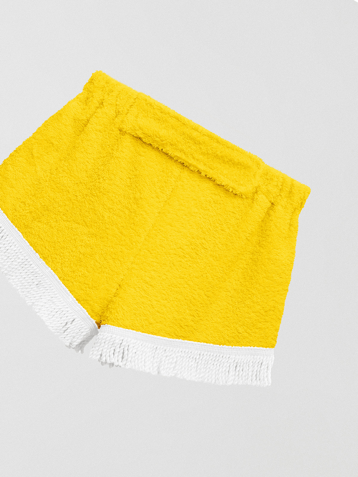 Towel shorts made in yellow cotton with white fringes. 